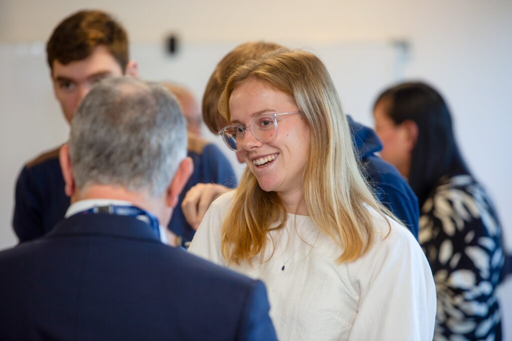 Image of a blonde girl talking to a man
