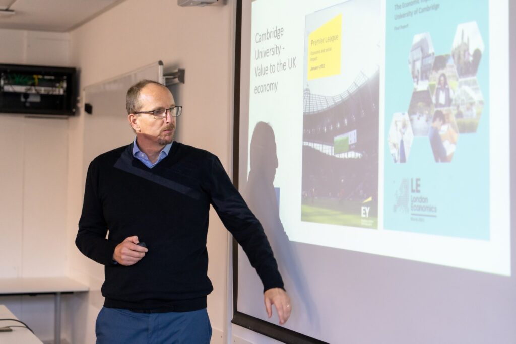 A man presenting using a projector